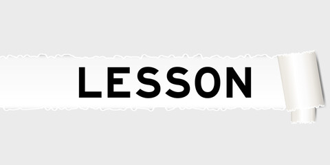 Ripped gray paper background that have word lesson under torn part