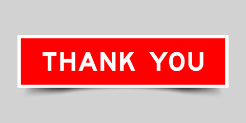 Square sticker label with word thank you in red color on gray background