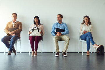 Naklejka premium Interview, people and thinking in waiting room for business, job opportunity and anxiety in office. Recruitment, candidates and inclusion in onboarding for diversity, hiring and application at agency