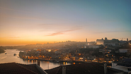 View of illuminated Porto city and Douro river and Dom Luis bridge I from famous tourist viewpoint...