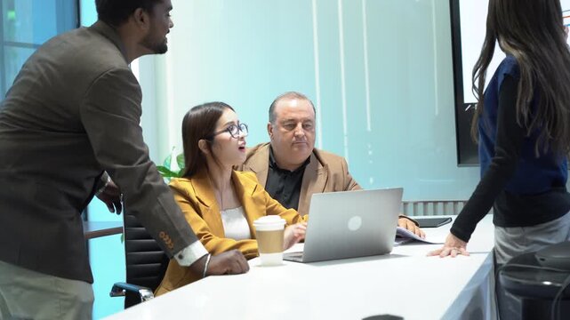 group of diversity business people brainstorming and talking with laptop computer on table in meeting at office . senior manager and Multi Ethnic Group colleagues working together in company teamwork