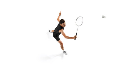Concentrated young man, badminton playing in black sportswear in motion with racket, hitting shuttlecock, training isolated on white background. Sport, competition, active, healthy lifestyle concept