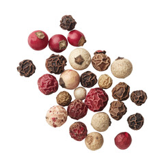 Close-up of colorful peppercorns, black, white, pink and green peppercorns.  A mix of spices on a black background.