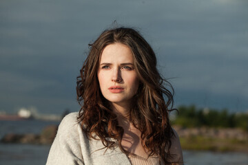 Perfect healthy brunette woman with long hairstyle and fresh skin walking outdoors