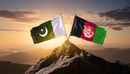 Pakistan and Afghanistan Flags Raised on a Mountain Peak at Sunrise