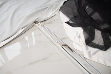 White cornice for curtains, white curtain and black tulle