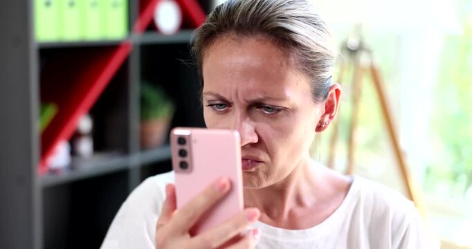 Woman with poor eyesight reading news on internet and is surprised 4k movie slow motion. Fake in social media concept