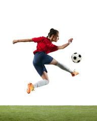 Young, athlete, female football player intense action captured mid-kick, showcasing agility and focus. Concept of women and sport, team games, movement, victory, action. Ad