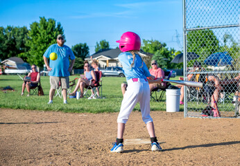 Youth girl softball player at bat during a game. © Lost_in_the_Midwest