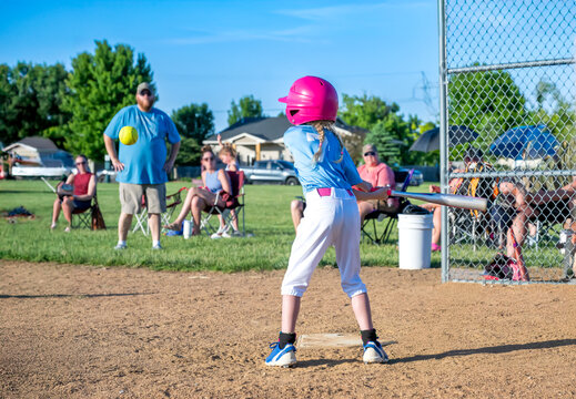 Youth girl softball player at bat during a game.