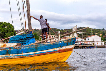 boat in the sea, with mountain and blue sky