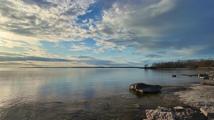 Prince Edward County Beach in Ontario view sun set. Calm Lake Ontario water in Canada at sunset. Prince Edward County Soup Harbour irregular headland or littoral made of limestone cliffs.