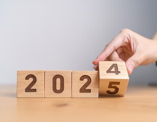 hand flipping block 2024 to 2025 text on table. happy new year 2025