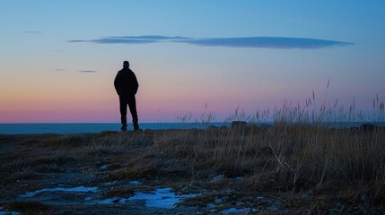 Solitary Figure Silhouetted Against a Dramatic Sky.