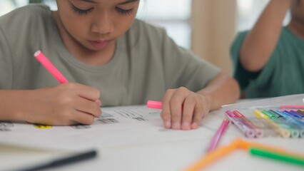 Two children are playing with a science experiment involving water