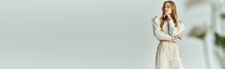 A woman stands thoughtfully amidst vibrant flowers, embracing nature's beauty.