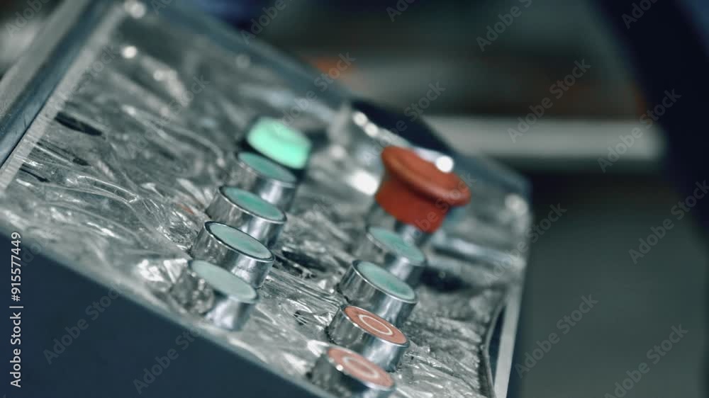 Poster close-up of a control panel with green and red indicator lights vibrating, showcasing equipment oper