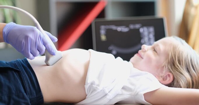 Doctor conducting ultrasound examination of internal organs of child in clinic 4k movie. Diagnosis and treatment of diseases of liver and biliary tract in children concept
