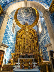 Main altar of Igreja de Sao Lourenco church in Almancil, Portugal, with religious sculptures and...