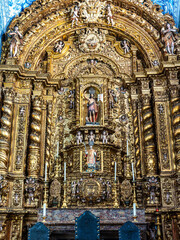 Main altar of Igreja de Sao Lourenco church in Almancil, Portugal, with religious sculptures and...