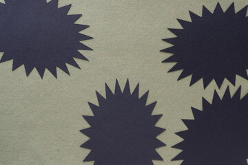 black paper starbursts on green