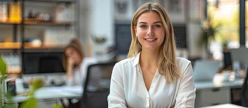 Poster An appealing businesswoman seated on a desk in the office. with copy space image. Place for adding text or design