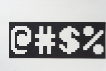 black paper machine-cut stencil with punctuation symbols on white