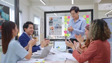 Modern office with an Asian business team sharing creative ideas. Collaborative professionals brainstorming strategies in a sleek, innovative environment, promoting teamwork and diversity