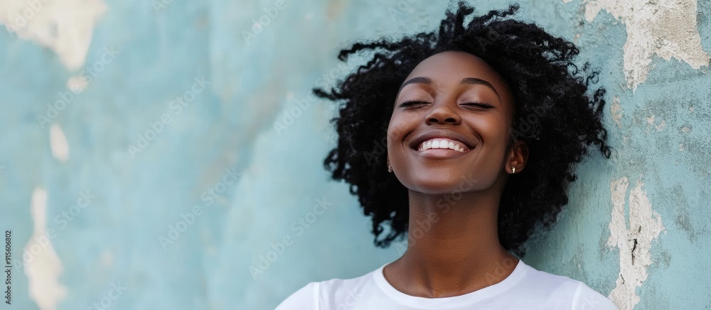 Aufkleber joyful smiling african american girl or woman against a wall background on the street. with copy spa