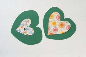 dainty floral and solar hearts on a plump green paper hearts
