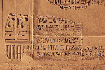 The wall fragment with Egyptian hieroglyphics in Karnak Temple. Luxor, Egypt