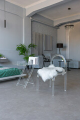 stylish discreet interior of the sleeping area in a modern studio in white-gray colors with green plants. daylight and no people inside