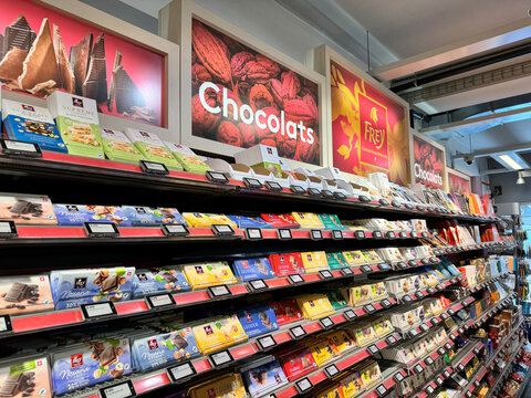 Geneva, Switzerland - July 29, 2024: Huge display of Swiss chocolates for sale in a Migros grocery store