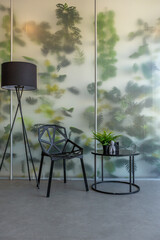 a spectacular area with a table and chair against the backdrop of a transparent designer partition...