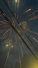 firework behind telephone wires