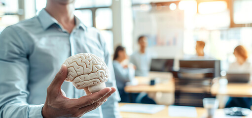 Businessman holding a brain icon with an office background, in the style of a digital twin concept of human interface technology for creative thinking and intelligence. A business manager or employee 