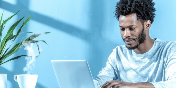 Morning Serenity Biracial Adult Man Working on Laptop While Enjoying Lions Mane Mushroom Tea in a Home Office, Highlighting Mental Clarity and Balanced Lifestyle - Powered by Adobe