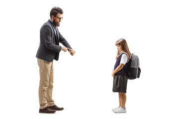 Full length profile shot of a man reprimanding a schoolgirl and pointing at a watch