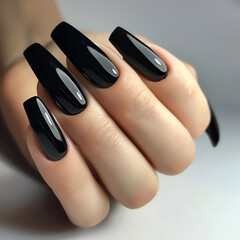 Elegant long black nails with a sleek, modern design on a clean background.