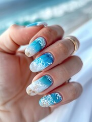 Ocean-themed nail art featuring waves and sky motifs