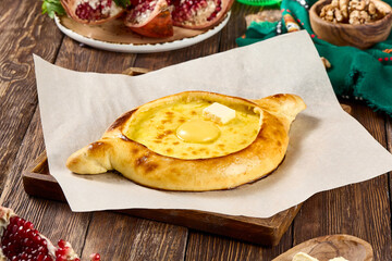 Adjaruli Khachapuri with Egg on Wooden Table - Traditional Georgian Cuisine