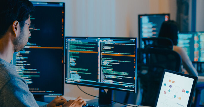 Group Adult Asia male, female freelance typing write prompt AI bot IT app smart program nomad, video game, terminal with coding language, designer, big data center on desktop computer in night office.