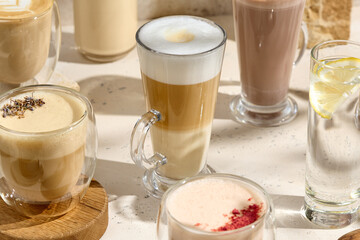 Assortment of Coffee Lattes and Beverages in Glass Cups on a Bright Surface