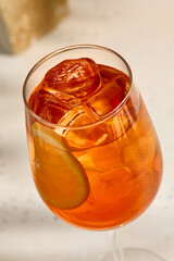 Aperol Spritz Cocktail with Orange Slice and Ice Cubes in Wine Glass - Refreshing Summer Drink