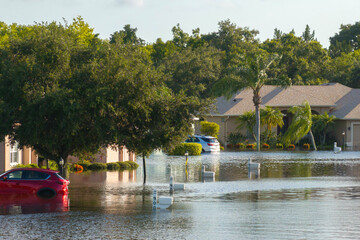 Flooded residential area with underwater houses and cars from hurricane Debby rainfall water in...