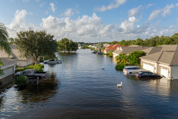 Flooded residential area with underwater houses and cars from hurricane Debby rainfall water in...