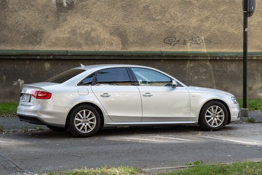 Luxury Audi A4 B8 sedan car parked on street, rear side view