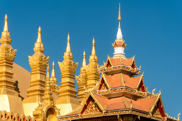 Fototapeta premium of The stupa of Pha That Luang a large, gold-covered Buddhist stupa and a national symbol in the center of the city of Vientiane, capital of Laos.