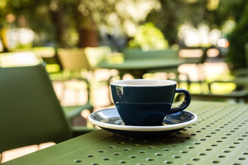 A cup of black coffee on a cafe terrace