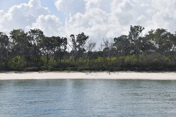 Sailing on the crystal clear turqoise blue water around the white sand beaches of Fraser Island in...